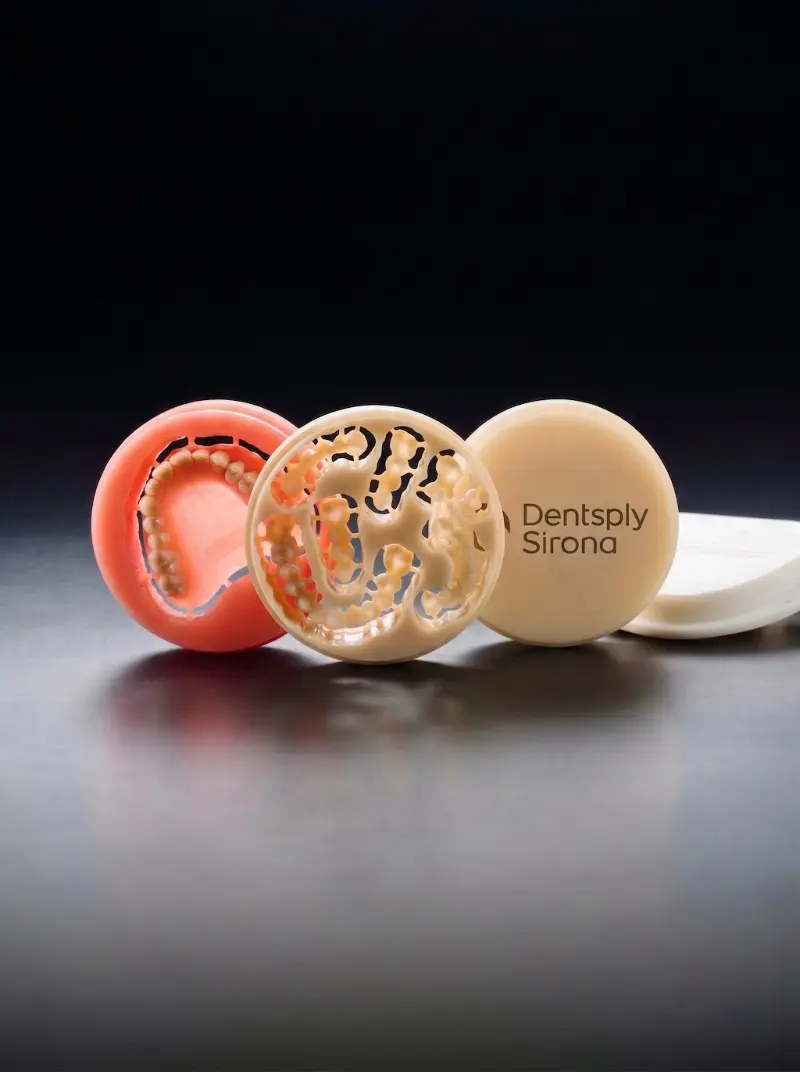 Premium Dentsply Sirona monolithic milling discs used to craft custom digital dentures at Confidentures in Auckland. The intricate, zero-shrinkage milled frameworks demonstrate the advanced dental technology used to guarantee absolute retention, perfect fit, and natural acoustics for our patients.